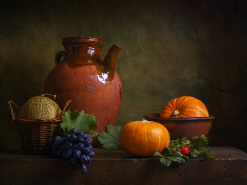 Still life with pumpkins and grapes