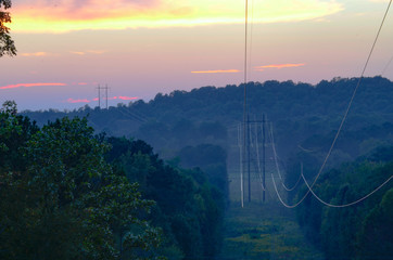 High-voltage power lines cut through the woods and over Coldwater Mountain near Coldwater, Alabama, USA