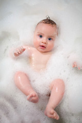 baby in foam in bathroom