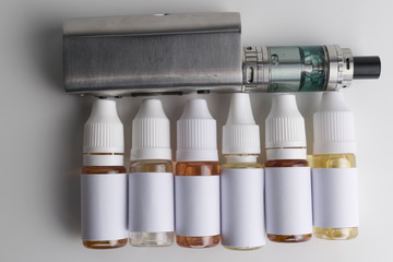 Isolated e liquid bottles and electronic cigarette, e cig for vape devices over a white background