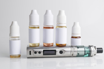 Isolated e liquid bottles and electronic cigarette, e cig for vape devices over a white background