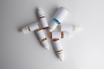Isolated e liquid bottles and electronic cigarette, e cig for vape devices over a white background