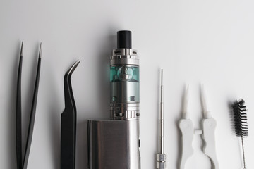 Isolated e liquid bottles and electronic cigarette, e cig for vape devices over a white background