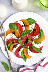 Traditional italian tomato salad caprese with mozzarella and basil.Top view .