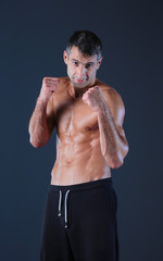 Fototapeta premium Profile view of young man practicing boxing .Personal instructor. Personal training.