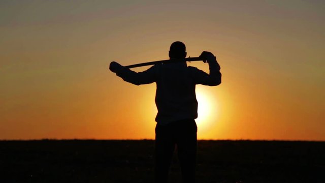 Portrait of a man with a sword at sunset, the path of a warrior. Samurai yakuza with a sword at sunset of the day.

