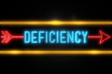 Obraz premium Deficiency - fluorescent Neon Sign on brickwall Front view