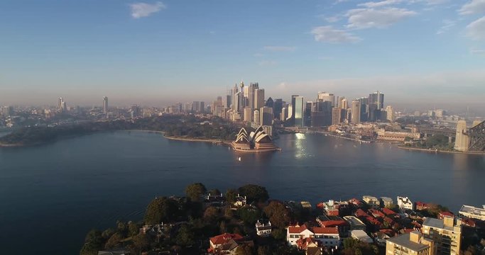 Wide panoramic rotation above Sydney Harbour from Fort Denison to wealthy North Shore suburbs of Sydney in soft morning sun light.