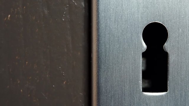 Closeup of key hole in old wooden door without key. Dolly sliding shot 4K ProRes HQ codec