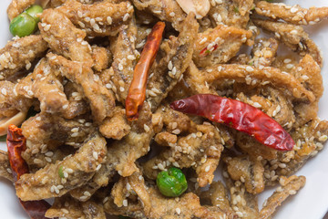 fried crispy tiny fish on plate