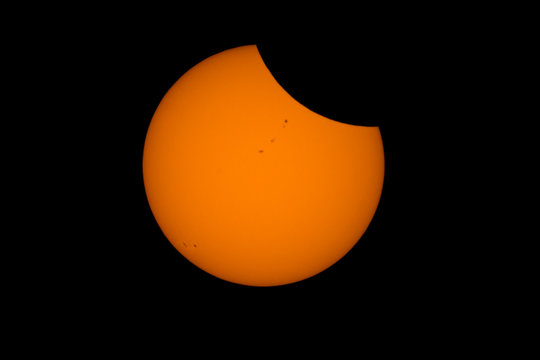 The Moon Begins To Occult The Sun Shortly After The Beginning Of The 2017 Total Solar Eclipse With Multiple Sunspots Appearing On The Sun's Face