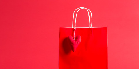 Gift bag with heart on a red background