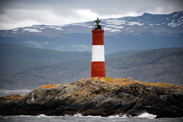 Red and white lighthouse in the Beagle Channel, Ushuaia, Tierra del Fuego, Argentina.  People call it End of the world's lighthouse.  It's name is Les Eclaireus.