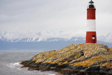 Red and white lighthouse in the Beagle Channel, Ushuaia, Tierra del Fuego, Argentina.  People call it End of the world's lighthouse.  It's name is Les Eclaireus.