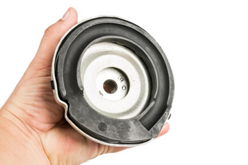 Shock absorber top mounting kit in the hand isolated above white