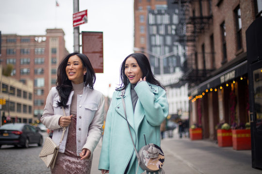 Two girlfriends are walking on the street in meat packing district, New York