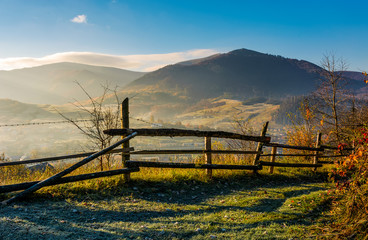 wooden fence near forest in mountains