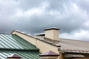 new metal roofs of old houses wet after the heavy rain