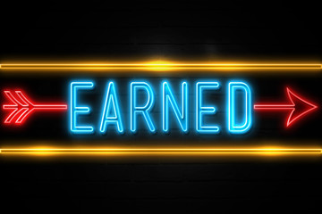 Earned  - fluorescent Neon Sign on brickwall Front view