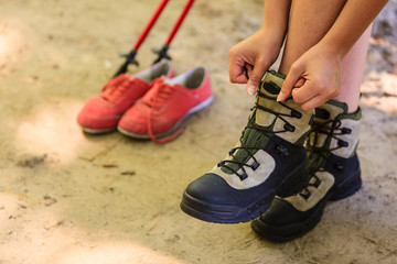 Girl compare footwear.