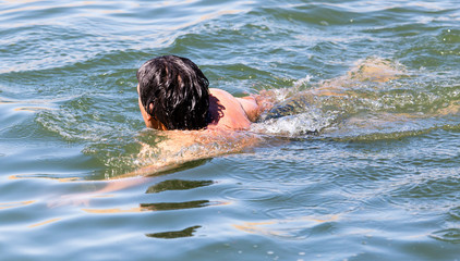 The man is swimming in the lake