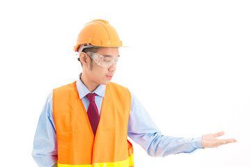 Young confident asian man, orange safety hat, orange safety jacket, safety glass, red tie, blue shirt on white posing open hand.