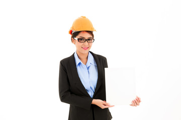 Young attractive confident asian woman, orange safety hat, glass, black suit, blue shirt on white background holding white card.