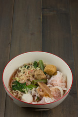 noodle in bowl on wooden table.