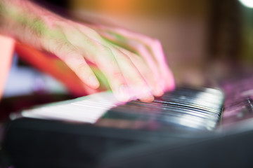 Musician plays keyboards in a rock band