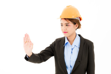 Young confident asian woman, orange safety hat, black suit, blue shirt on white pointing palm.