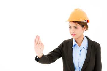 Young confident asian woman, orange safety hat, black suit, blue shirt on white pointing palm.