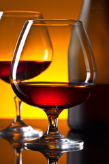 glasses of brandy on the reflective background