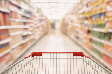 Abstract Supermarket aisle with empty shopping cart