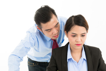 Young confident Asian office employee business man whisper close to attractive Asian office woman ear.