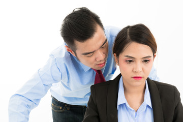 Young confident Asian office employee business man whisper close to attractive Asian office woman ear.