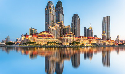 Fototapeta na wymiar illuminated city waterfront downtown skyline with Haihe river,Tianjin,China.
