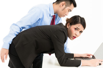 Young confident Asian office employee business man touching bended attractive Asian office woman...