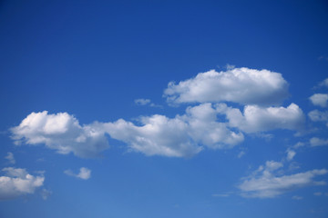 Fototapeta na wymiar Summer blue sky with small white clouds