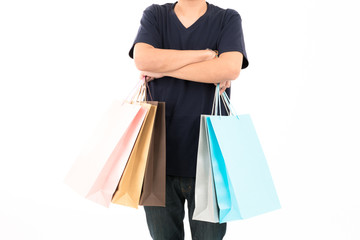 Young confident attractive Asian blue shirt man with shopping bags standing with portrait on white background.