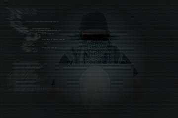 Asian cyber attacker hacking with powerful laptop.