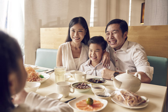 Family portrait in a restaurant over lo hei