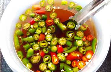 fish oil sauce with red and green chili in ceramic bowl