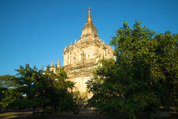 The ancient Buddhist temple of Gawdaw-palin in beams setting the sun. Bagan, Burma