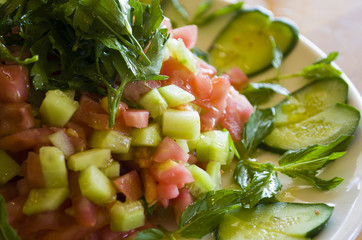 Salads and heart-shaped peppers on a wooden table