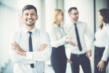The happy businessman stand near partners