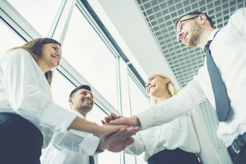 Obraz premium The business people hold hands together