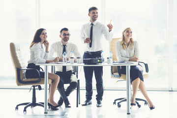 The four business people look a presentation near the projector