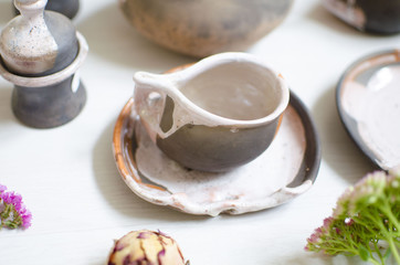 Set of dishes for coffee from clay. Decorative cerasmics. Pottery cups and dishes