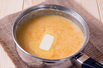 Cooking pumpkin porridge with a slice of butter