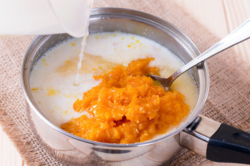 Cooking pumpkin porridge with milk in a saucepan